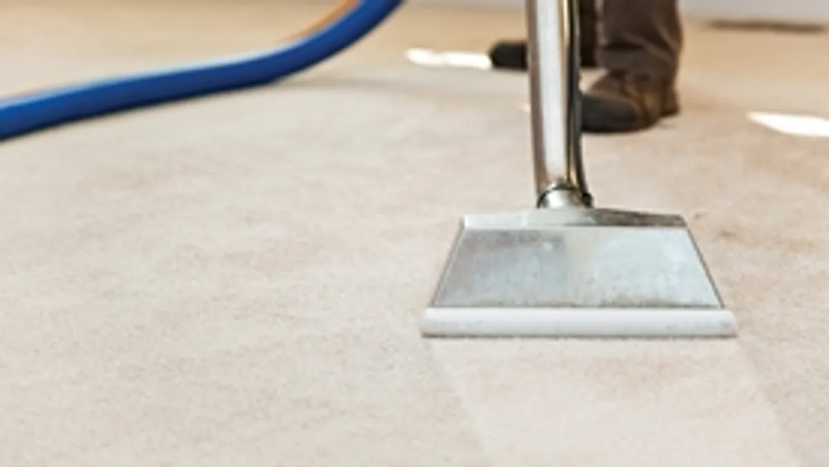 Carpet cleaning wand head gliding over a light carpet during hot-water extraction, Riverside, CA.